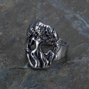 Macro detail of Tree of Life and skull engraving on vintage stainless steel ring