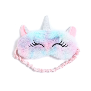 Detail of plush unicorn sleeping mask featuring soft macaron gradient faux fur and glitter horn