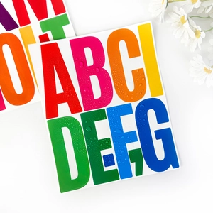 Close-up of waterproof 5-inch colorful alphabet stickers with visible water droplets