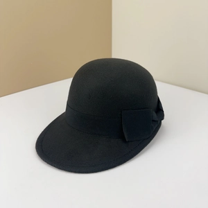 Close-up of black wool felt equestrian hat featuring a grosgrain ribbon and bow detail