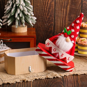 Christmas Santa Gnome candy box with Noel banner on a rustic wooden holiday tabletop