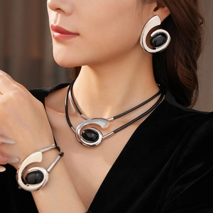 Detail of vintage oval black stone and silver spiral jewelry set on a model