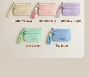Three-layer zippered coin pouches in pastel colors with fuzzy wrist straps and lettering