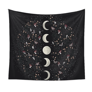 Detail of moon phase wall tapestry with botanical moth patterns on black fabric