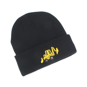 Detailed close-up of a black knit beanie featuring a yellow excavator embroidery