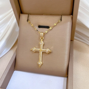 Detailed view of micro-paved zircon cross necklace in a premium brown jewelry box