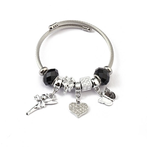 Detail of twisted cable bangle with angel, clover and butterfly charms and black beads