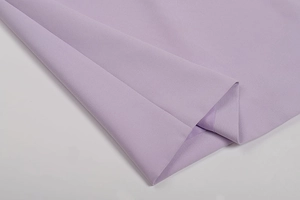 Detailed close-up of lavender slim-fit dress fabric showing fine texture and stitching