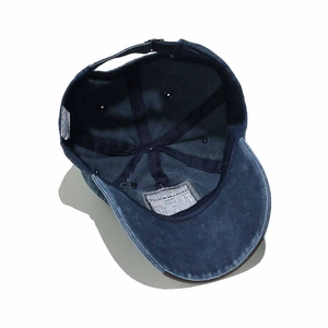 Detail view of cotton inner lining and washing label of vintage NY denim baseball cap