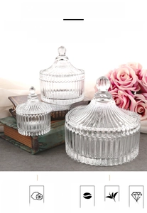 Three sizes of European glass storage jars with ribbed design and dome lids in a home setting