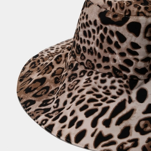 Close-up of classic leopard print fabric and fine stitching on a wide-brim sun hat