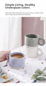 Detail of speckled ceramic mug with a wide circular handle in minimalist splash-ink style