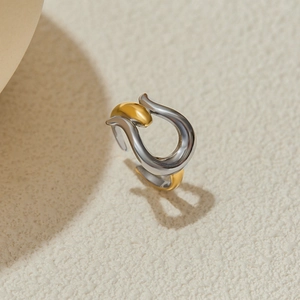 Macro shot of two-tone gold and silver liquid metal style adjustable open ring