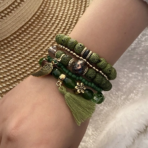 Bohemian multi-layer green beaded bracelet set with wing charms and cotton tassels