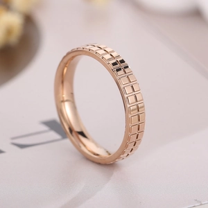 Macro close-up of 18k rose gold plated stainless steel ring with checkered pattern detail