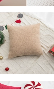 Detailed view of beige boucle wool Christmas pillow with holiday decorations and textures