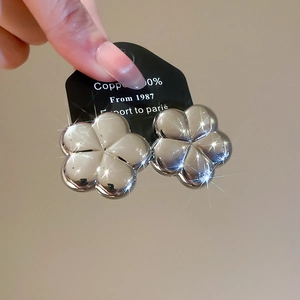 Detailed macro view of silver flower stud earrings made from 100% pure copper material