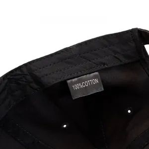 Detail of internal care label on a black washed cotton baseball cap with quality stitching