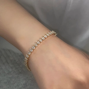 Detailed view of pear-cut cubic zirconia tennis bracelet in gold-plated finish
