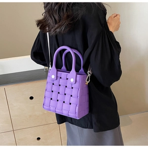 Close-up of purple woven EVA crossbody bag showing texture and detachable strap details