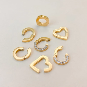 Detailed view of titanium steel heart and round jewelry connectors with crystal accents.
