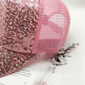 Detail of pink sequins and breathable mesh fabric on a stylish baseball cap for women