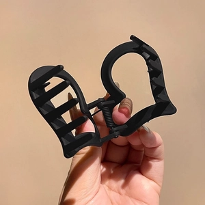 Matte black acrylic hair claw clip with double heart cutout design for high ponytail