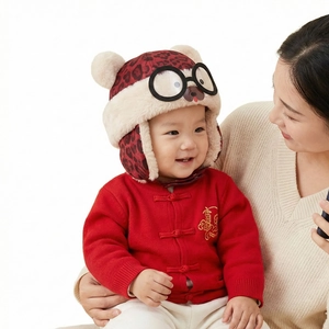 Detail of baby leopard print winter hat with faux fur lining and cute round glasses accent