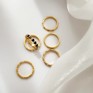 5-piece gold ring set featuring black heart enamel and sparkling cubic zirconia bands