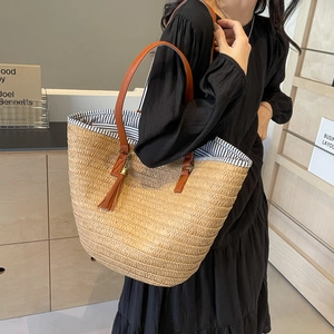 Large khaki straw woven tote bag with brown PU straps and tassel for seaside vacation