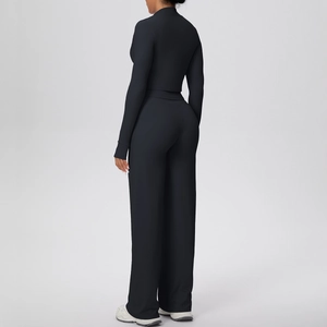 Detail view of the black high-waisted wide-leg yoga pants and long-sleeved crop top set