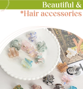 Detailed top view of assorted mini acrylic hair claws with elegant marble ink patterns