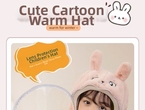 Close-up of pink plush children's winter hat with protective eye shield and rabbit ears