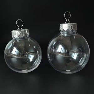 Close-up of 6cm transparent DIY bauble with silver snowflake embossed metal cap on dark background