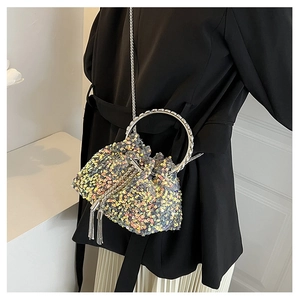 Detail of silver sequin bucket bag with metal ring handle and chain shoulder strap