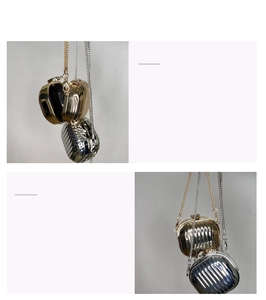 Macro detail of gold and silver mini acrylic metal purses with chain straps showing structure