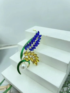Elegant wheat stalk brooch with blue and yellow crystals and a white pearl accent
