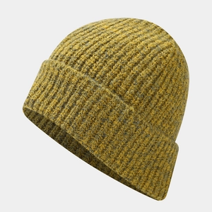 Detail of ginger yellow ribbed knit beanie showing thick texture and folded cuff