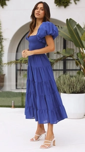 Detail of off-shoulder puff sleeves and pleated bodice on a royal blue tiered maxi dress