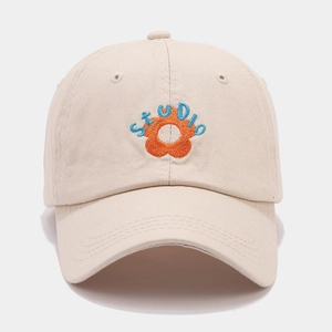 Detailed embroidery of orange flower and blue STUDIO text on beige cotton cap