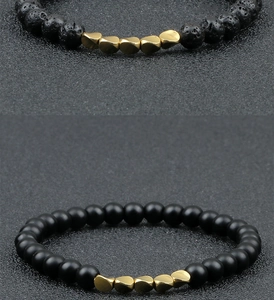 Macro shot of lava stone beads and irregular gold metal accents on elastic bracelet