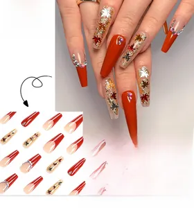 Close-up of autumn maple leaf press-on nails with sequins and glitter rhinestones