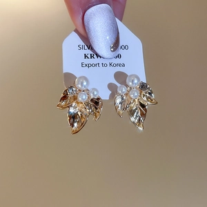 Détail des boucles d'oreilles feuille d'or en argent S925 avec perles et cristaux