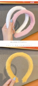 Detail of plush wide headband in white pink and yellow soft faux fur texture