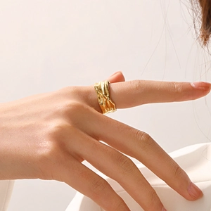 Adjustable golden irregular wrinkled metal ring worn on finger in a high fashion style