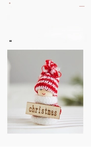 Detail of wool felt snowman ornament with striped hat and wood Christmas sign
