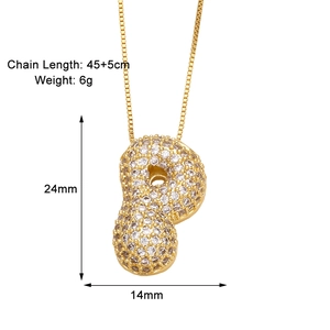 Detail view of gold letter P necklace pendant with clear cubic zirconia pavé setting