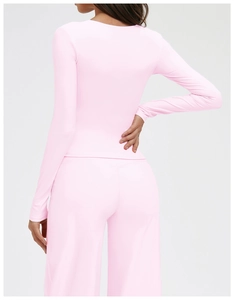 Back view of pink long sleeve yoga top and high waist flared leggings sports set