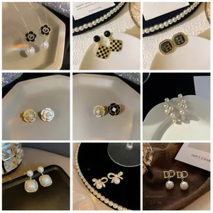Detailed grid view of luxury pearl and rhinestone earrings with camellia and H motifs