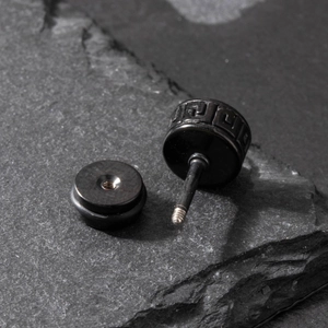 Men's black stainless steel stud earrings with Greek key pattern on stone background